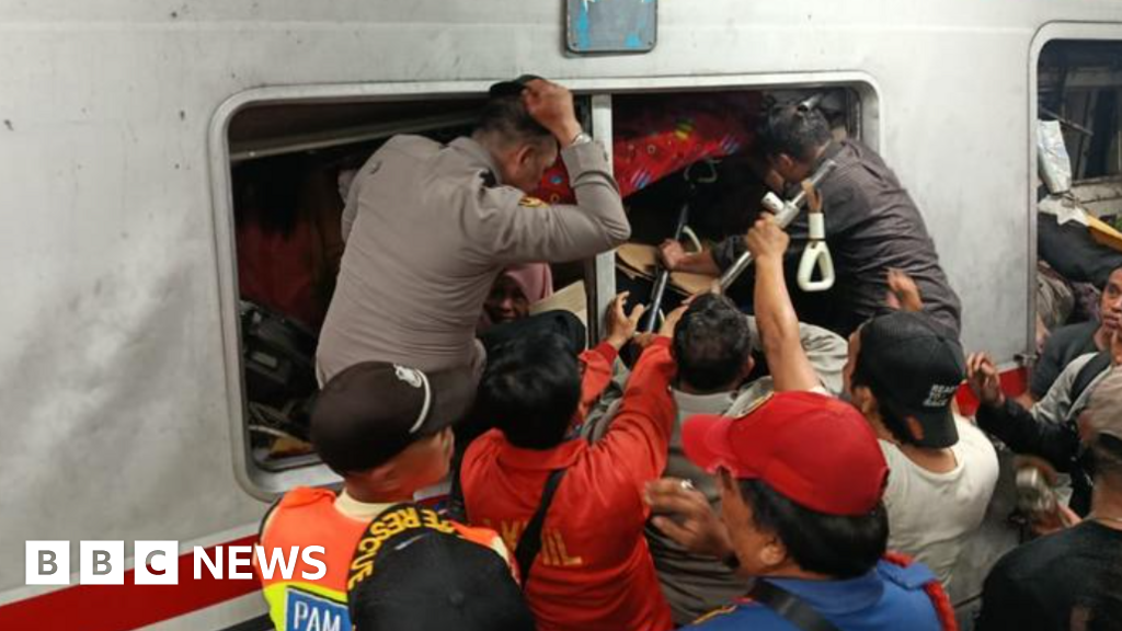 Rescuers try to free survivors trapped inside Indonesia train after fatal crash
